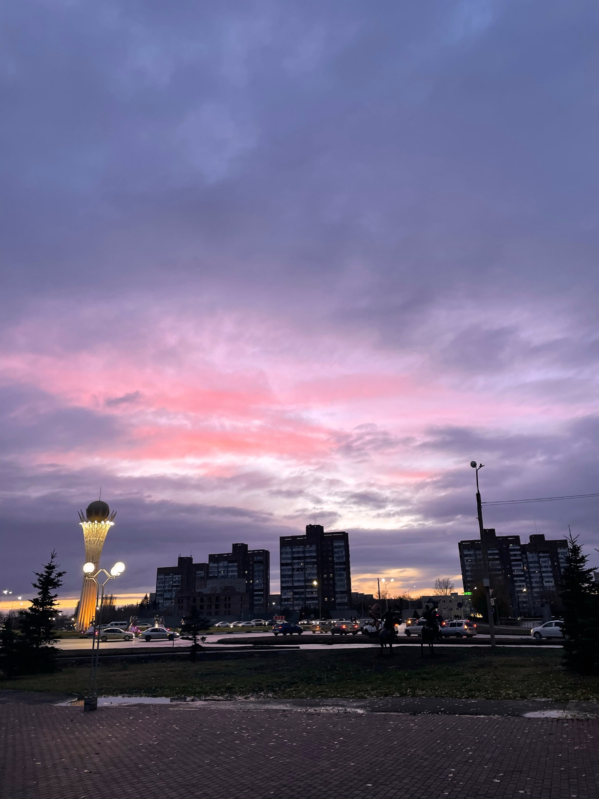A dramatic pink and violet sunset over the skyline of Ust-Kamenogorsk.