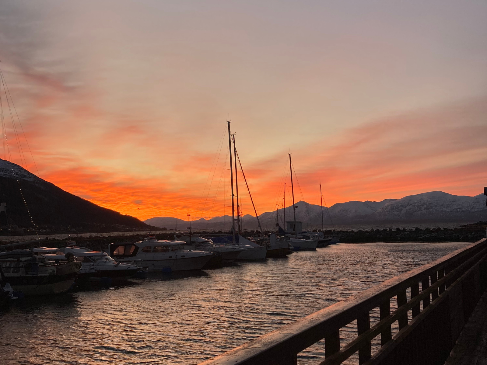 A fiery orange sunset over Tromsø harbour.