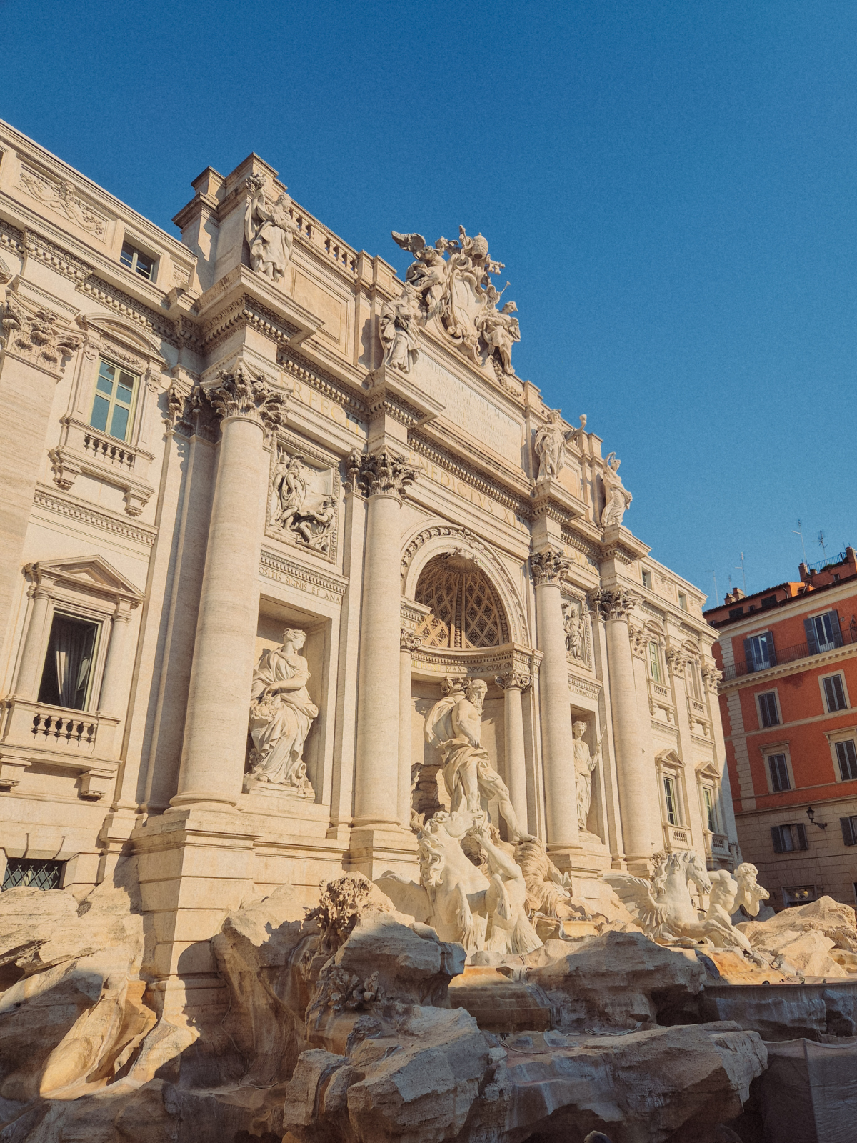 The Trevi Fountain in Rome bathed in early morning light.